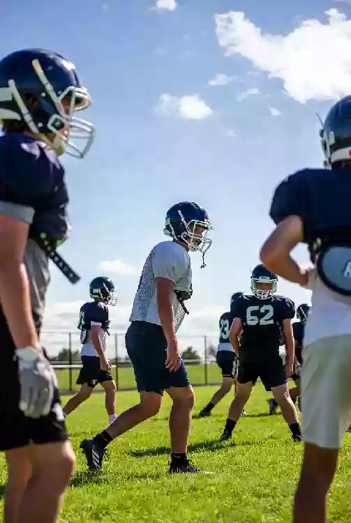 Vertical photo of high school football players practicing on the field in Shawnee Oklahoma