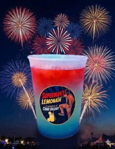 Red and blue Superman's Lemonade cup in front of fireworks at the Wetumka Oklahoma 4th of July block party