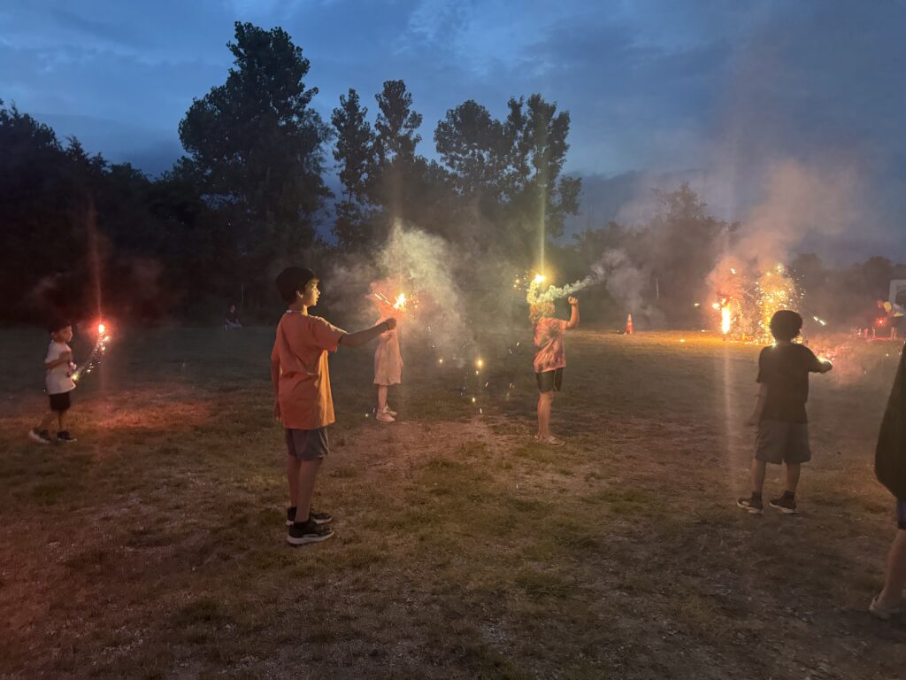 Children waving sparklers during the evening festivities at the Wetumka 4th of July community celebration in Oklahoma