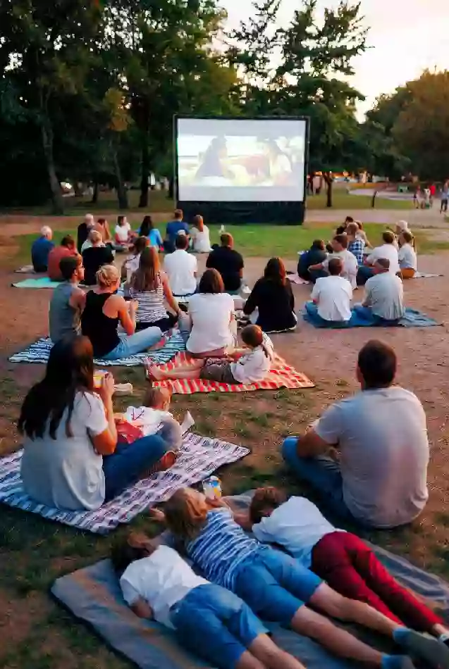 Families gathered on blankets for outdoor movie screening