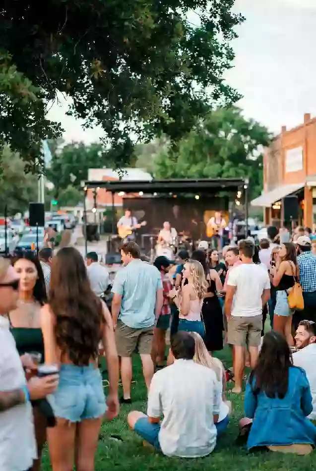 People enjoying a live outdoor music event in McAlester