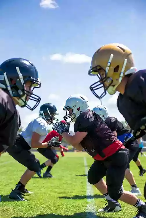 Vertical photo of high school football players practicing on the field in McAlester Oklahoma