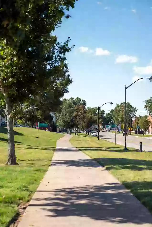Clean walking path and green space in a Sapulpa park