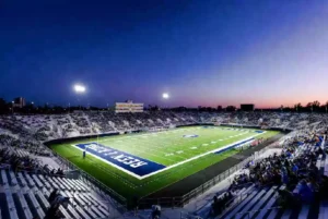 Wide view of a high school football stadium at dusk under stadium lights in Sapulpa Oklahoma