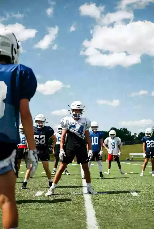 Vertical photo of high school football players practicing on the field in Sapulpa Oklahoma