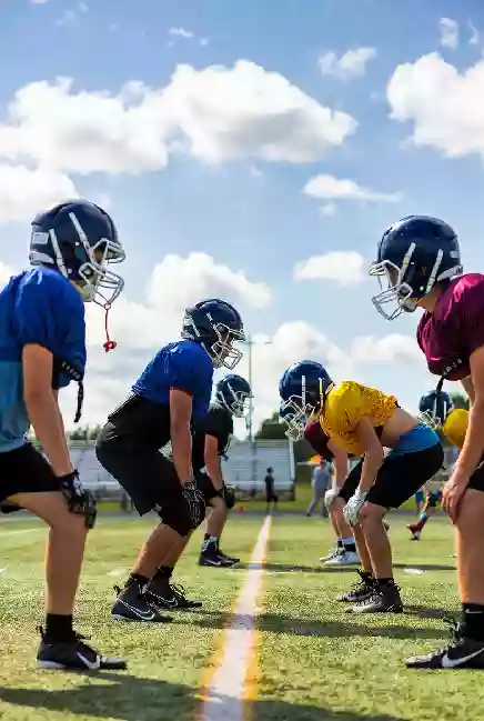 Vertical photo of high school football players practicing on the field in Stillwater Oklahoma
