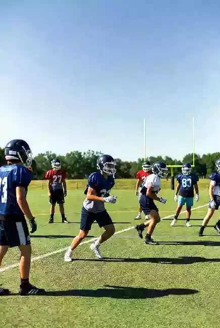 Vertical photo of high school football players practicing on the field in Bixby Oklahoma