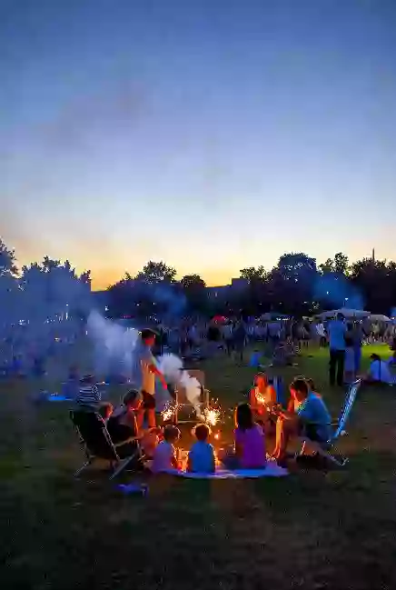 Families at a free outdoor community event in a Bartlesville park