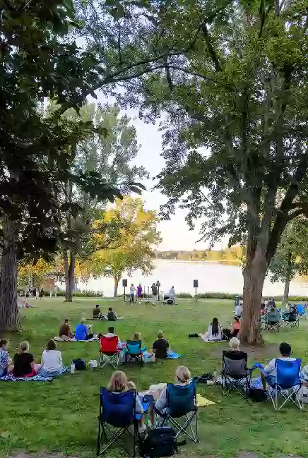 Families at a free outdoor concert or community event at a lake park in Ponca City