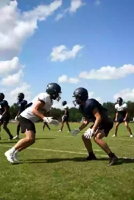 Vertical photo of high school football players practicing on the field in Ardmore Oklahoma