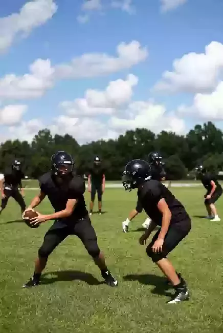 Vertical photo of high school football players practicing on the field in Sand Springs Oklahoma