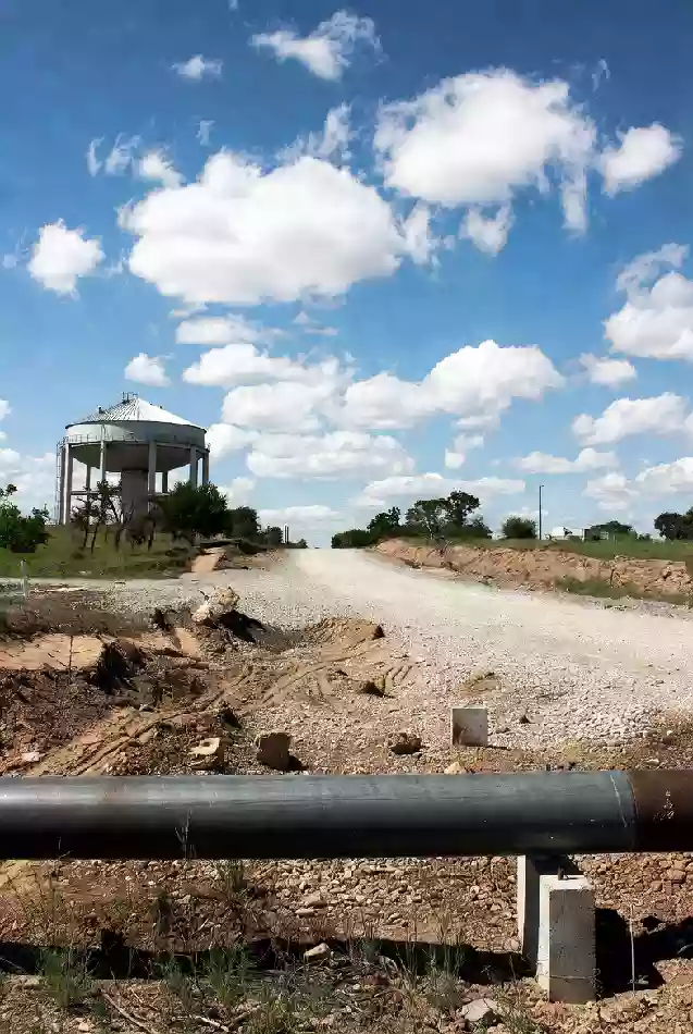Vertical view of rural road and elevated water storage infrastructure in Sequoyah County Oklahoma