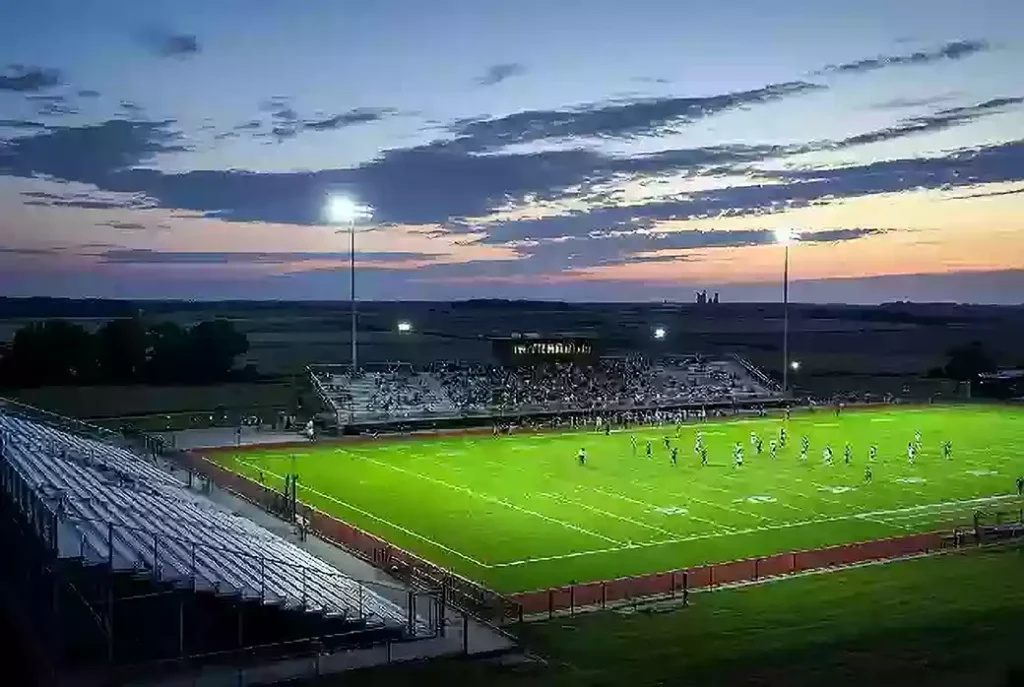 Wide view of a high school football stadium at dusk under stadium lights in Sequoyah County Oklahoma