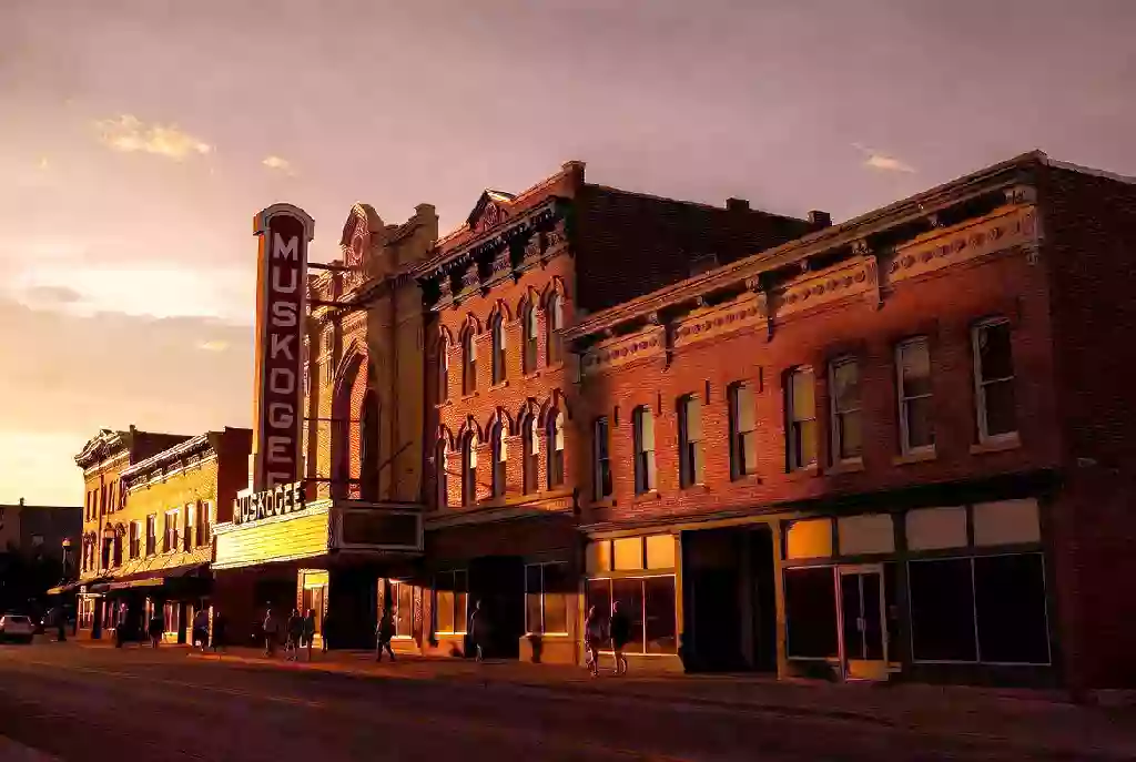Wide view of historic downtown Muskogee with MUSKOGEE theatre marquee at golden hour