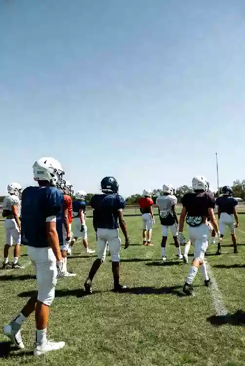 Vertical photo of high school football players practicing on the field in Muskogee Oklahoma