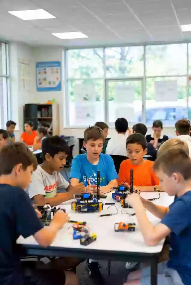Children engaged in hands-on robotics or STEM camp