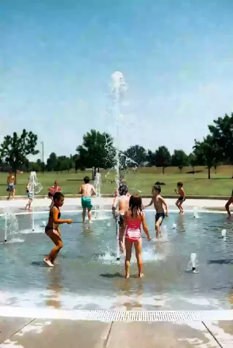 Public splash pad with children playing