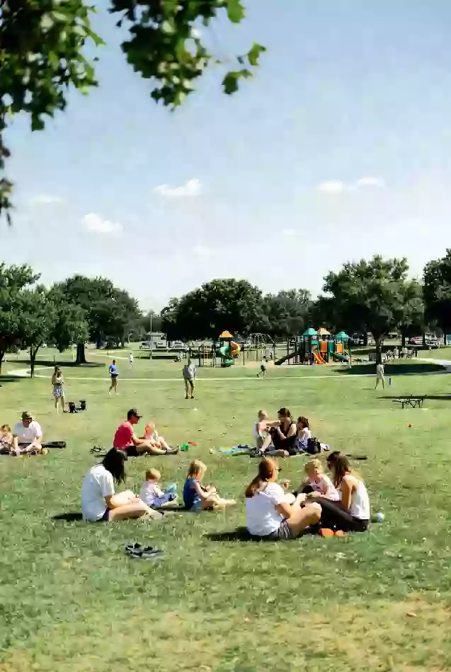 Families participating in outdoor activities at public park event